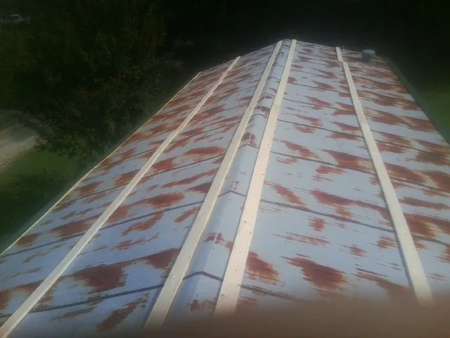 Rusted metal roof panels with new wood purlins before replacement — Storm Damage Roof Repair in Ewing by Roofing Brothers