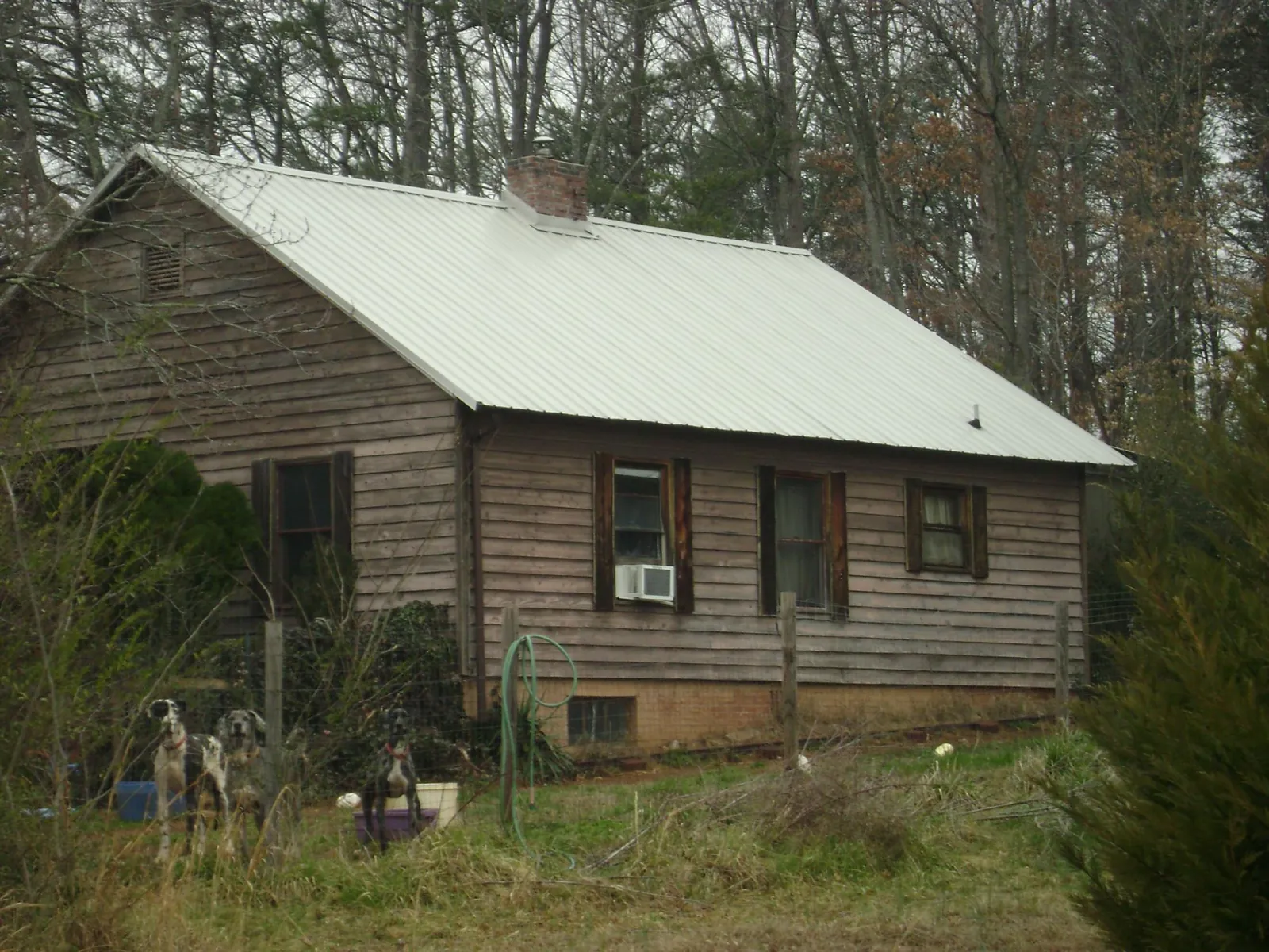 White metal roof on an old wood sided farmhouse, from a Metal Roof Installation job in Ewing